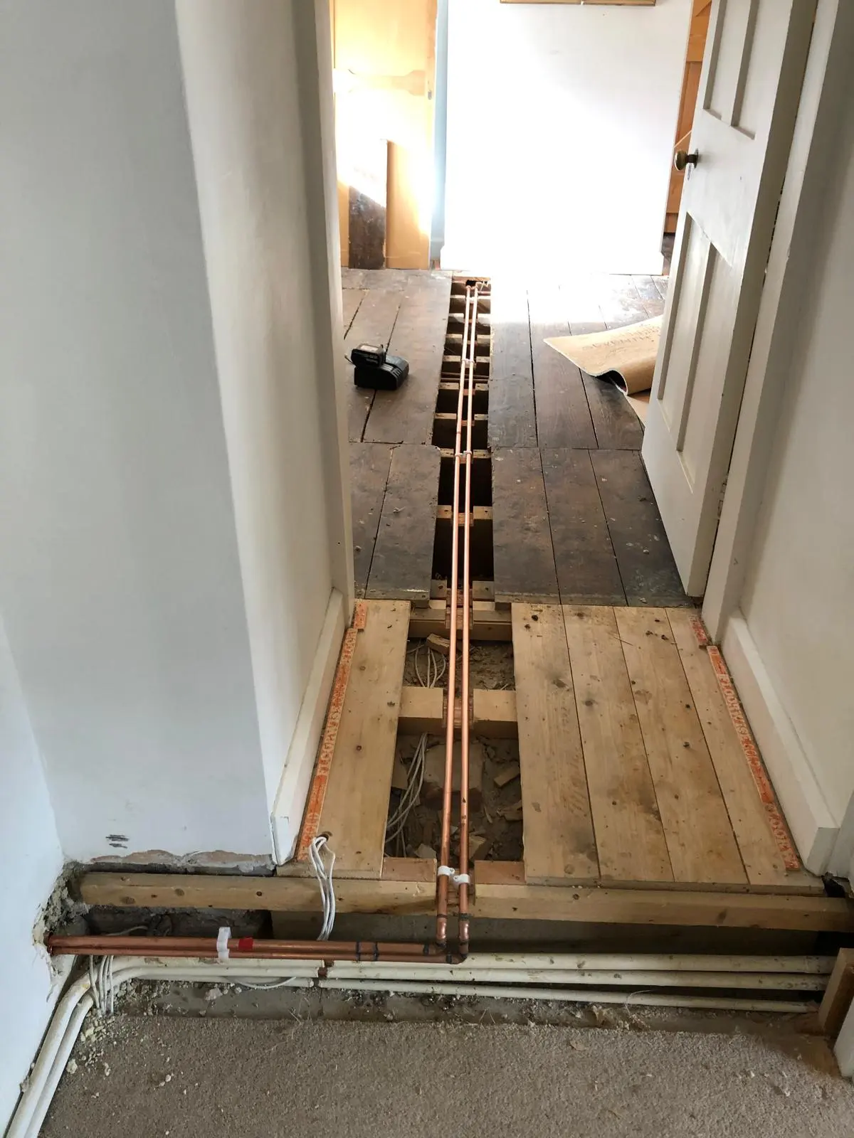 Professional copper pipe rerouting under floorboards by BC Plumbing in Frome