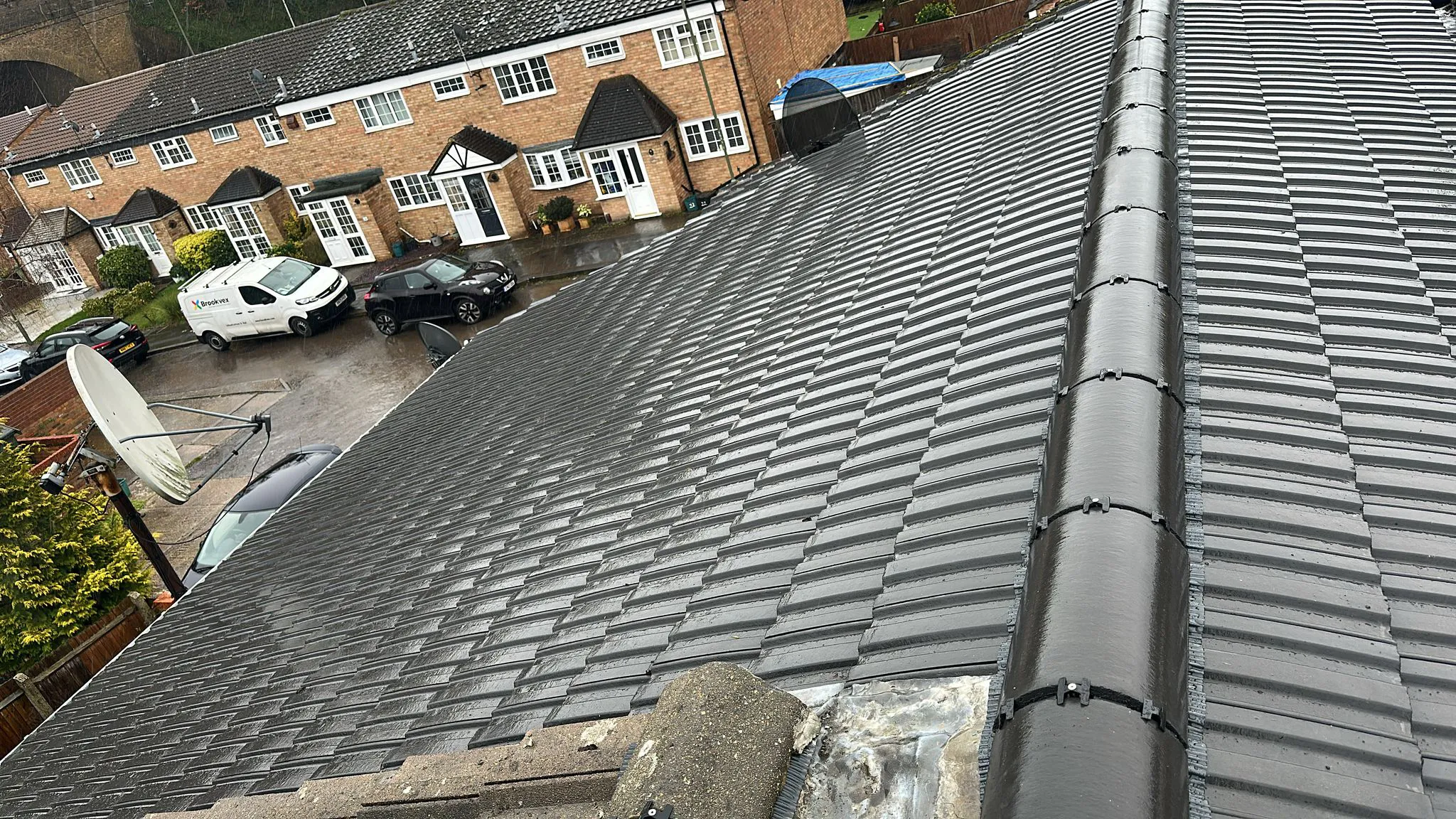 Mechanical dry ridge system and interlocking concrete tiles on a residential pitched roof in Plymouth