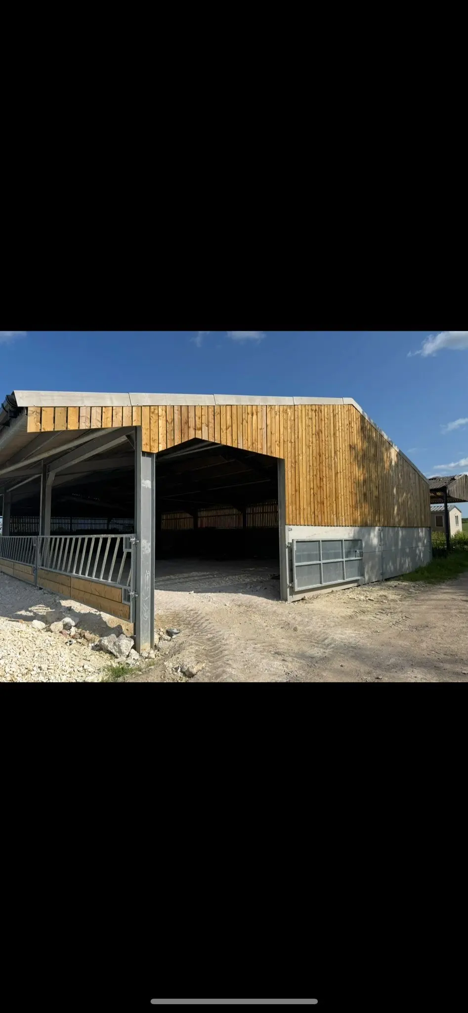 Newly built steel frame agricultural barn and livestock housing with timber cladding by ER3 Group LTD