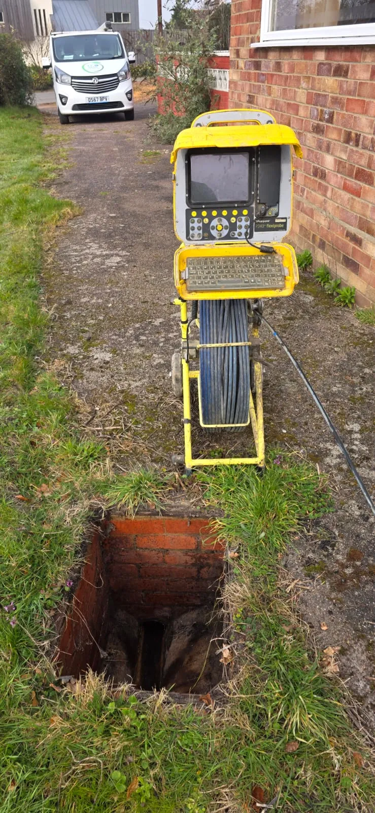 A P340 flexiprobe CCTV drain camera system positioned next to an open drainage inspection chamber.