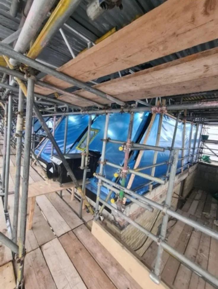 Scaffolding and blue polythene containment enclosure for professional asbestos removal by Stay Safe Environmental.