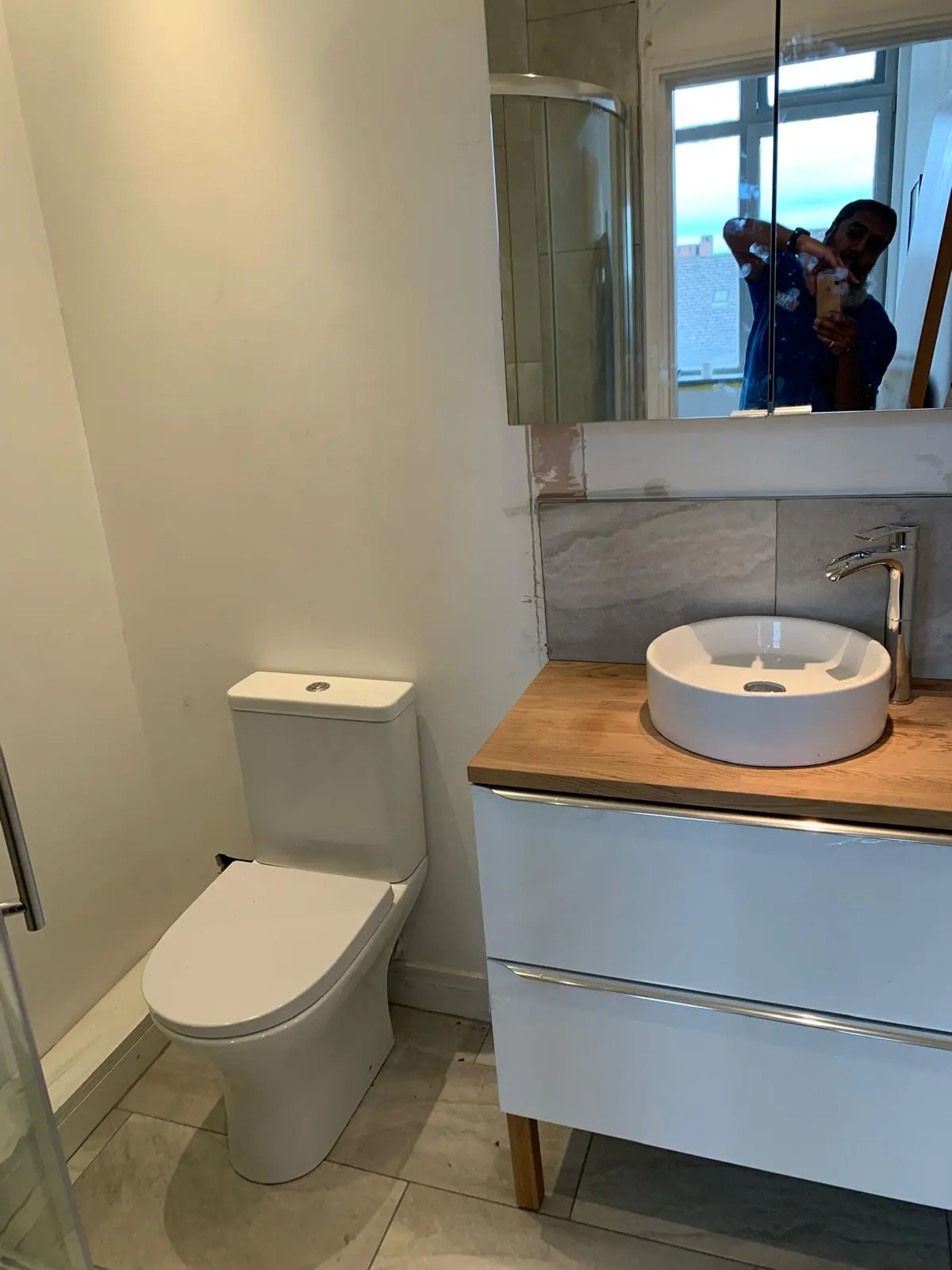 Modern bathroom plumbing installation by MK Plumbing LTD in Bolton, featuring a vanity unit and new toilet.