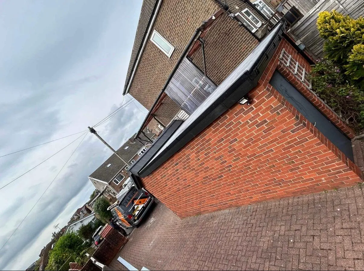 Professional flat roofing and guttering installation on a garage in Holmfirth.