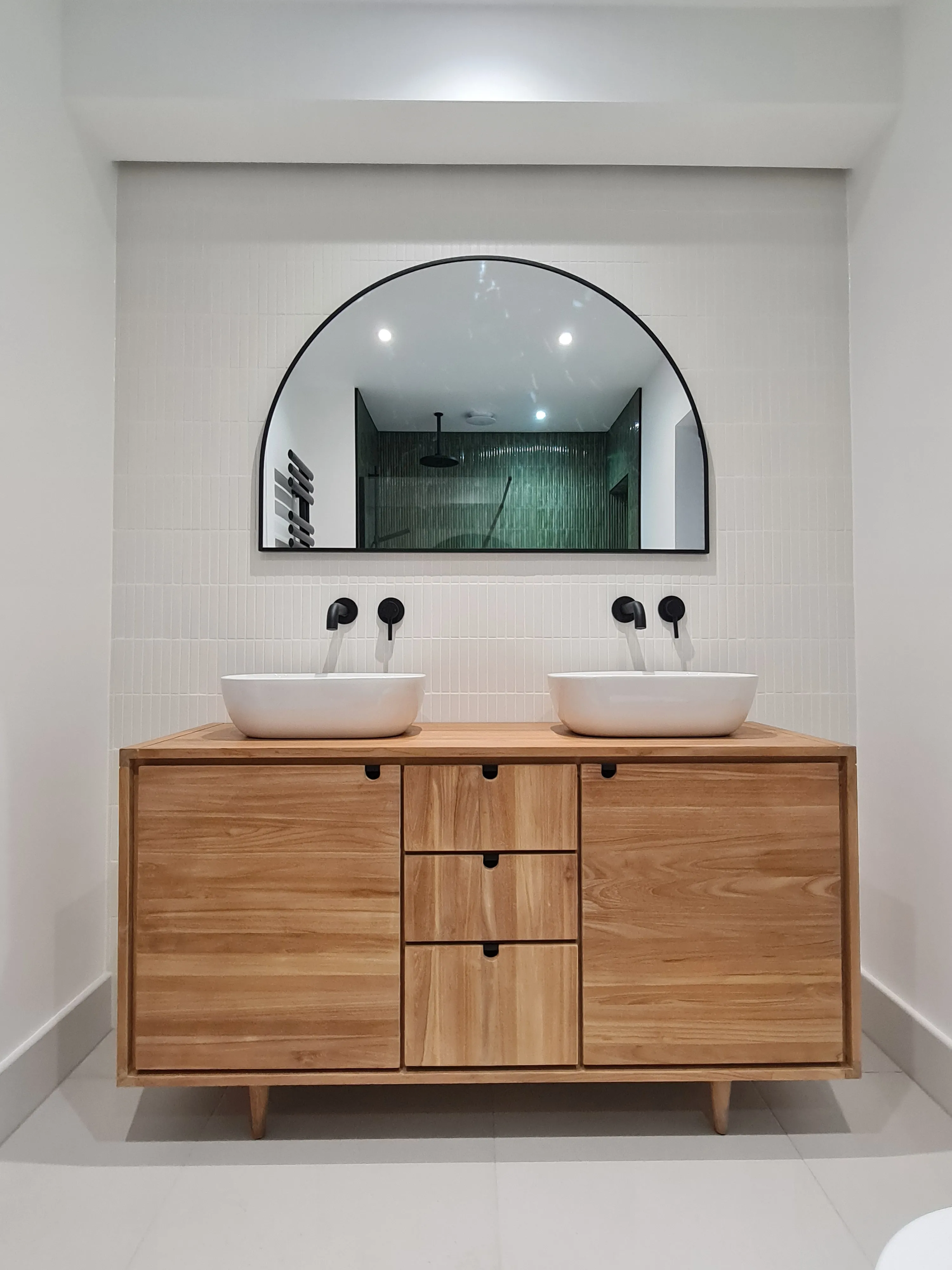 Bespoke master bathroom vanity unit with double vessel sinks and matte black taps installed by Sands & Vossen in Plymouth.