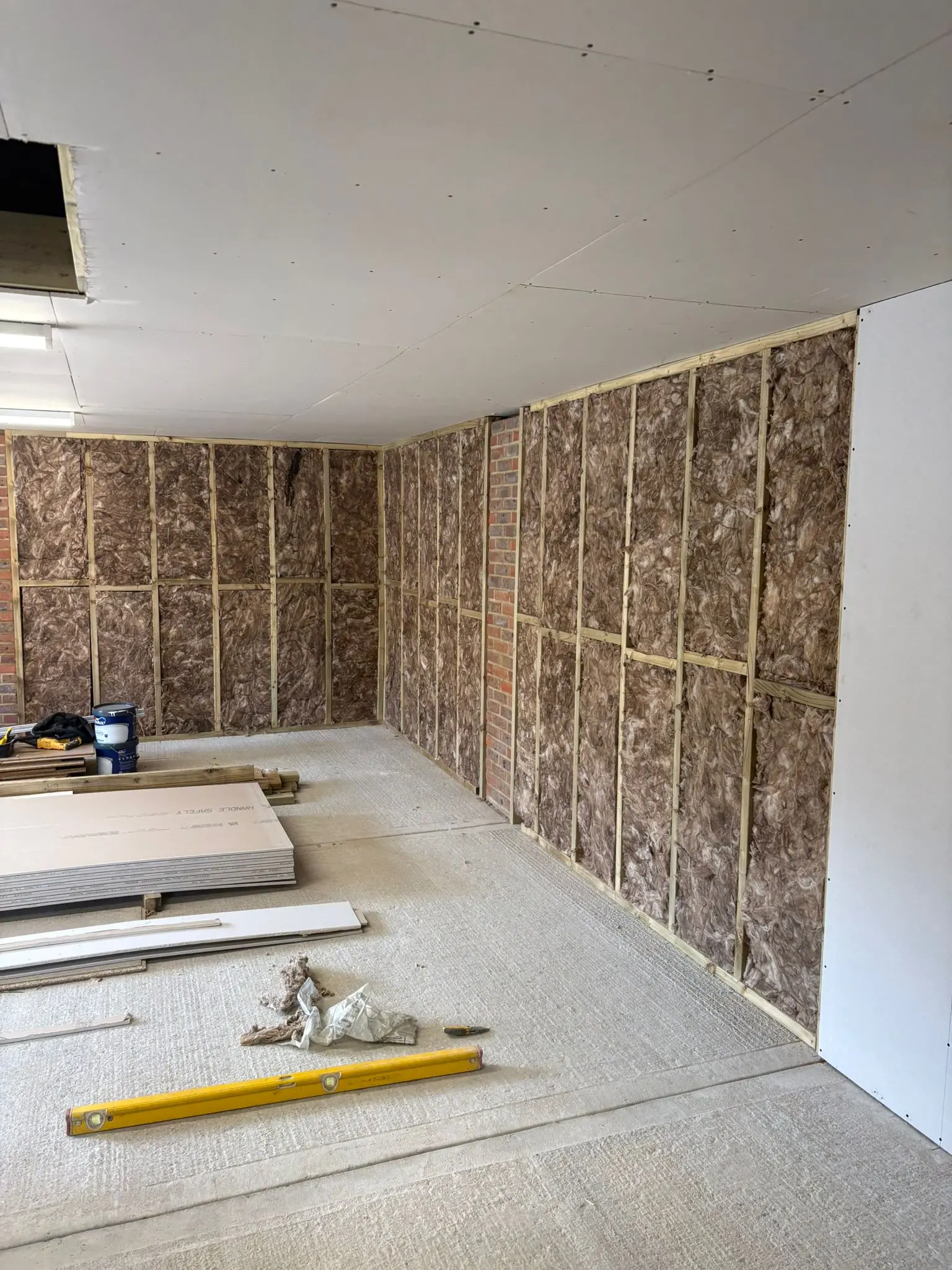 Wood stud wall with insulation during a garage conversion
