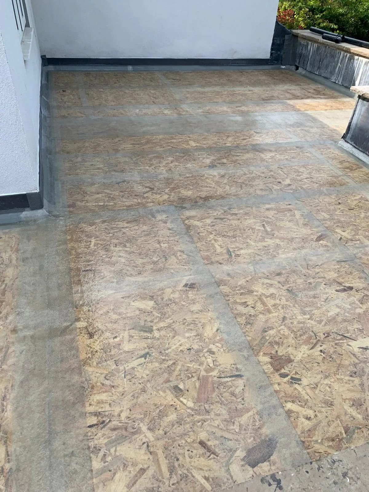 GRP fibreglass flat roof installation in progress on a residential balcony.