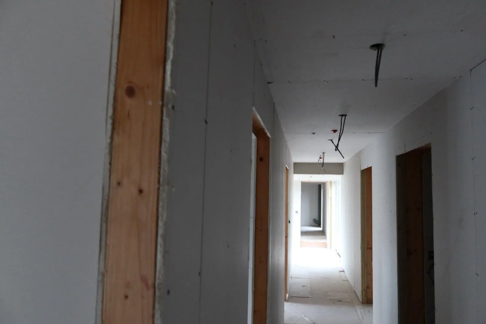 Newly installed plasterboard in a hallway during an internal wall insulation and retrofit project in South Wales