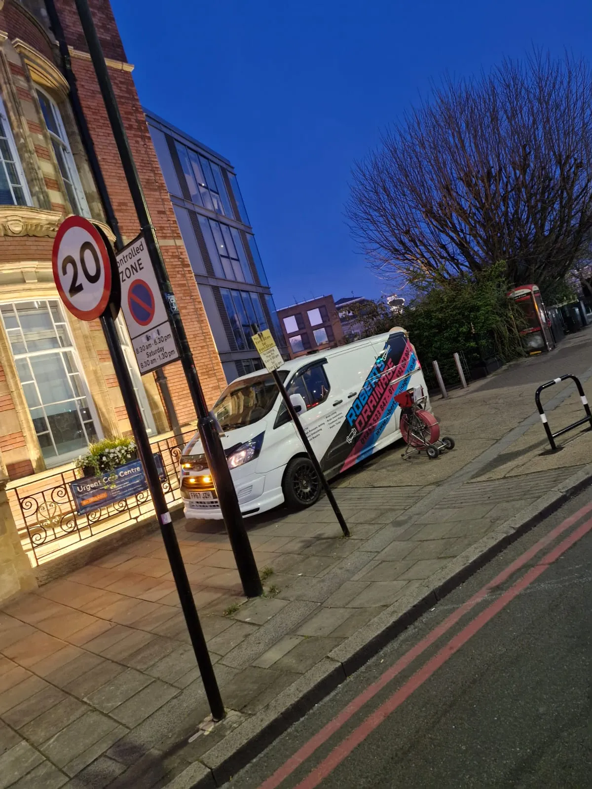 Roberts Drainage Ltd van and equipment parked on a street at night for emergency drain repairs.