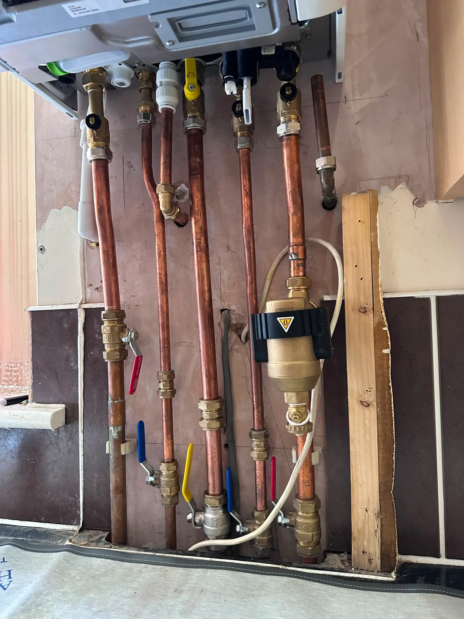 Under-boiler copper pipework and valves for a new combi boiler installation