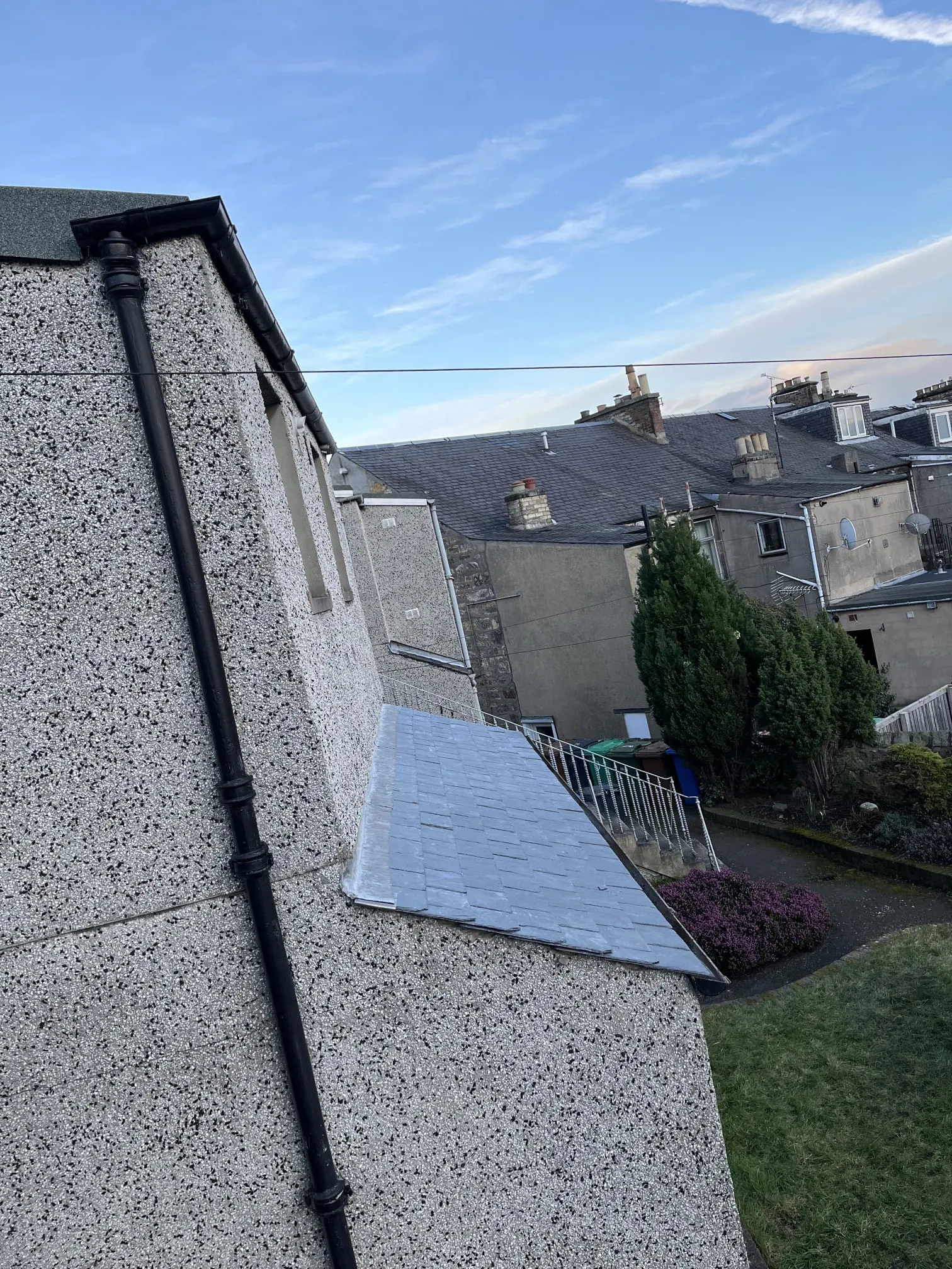 Roughcast exterior wall and slate roof with lead flashing on a Fife property