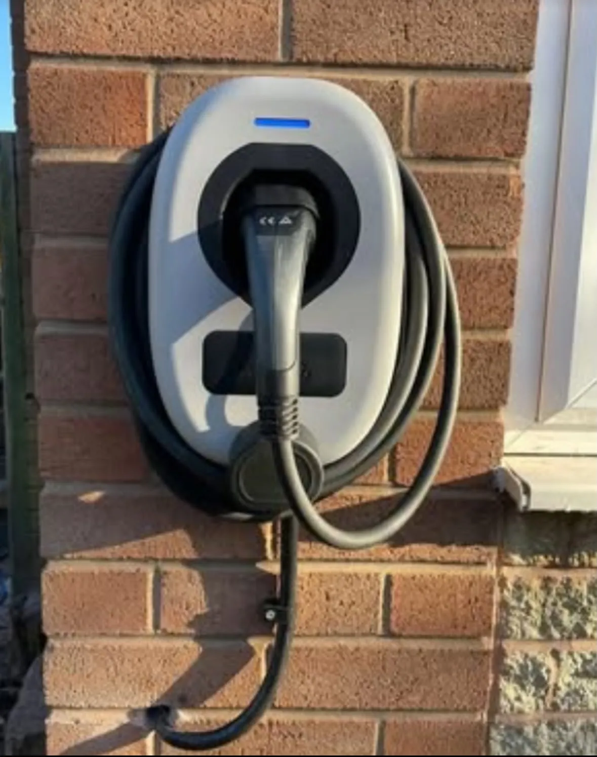 Domestic EV charger installation on an external brick wall by Sussex Brown Sparks