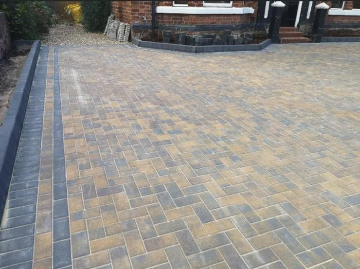 Newly installed multi-tonal block paving driveway with a charcoal grey border.