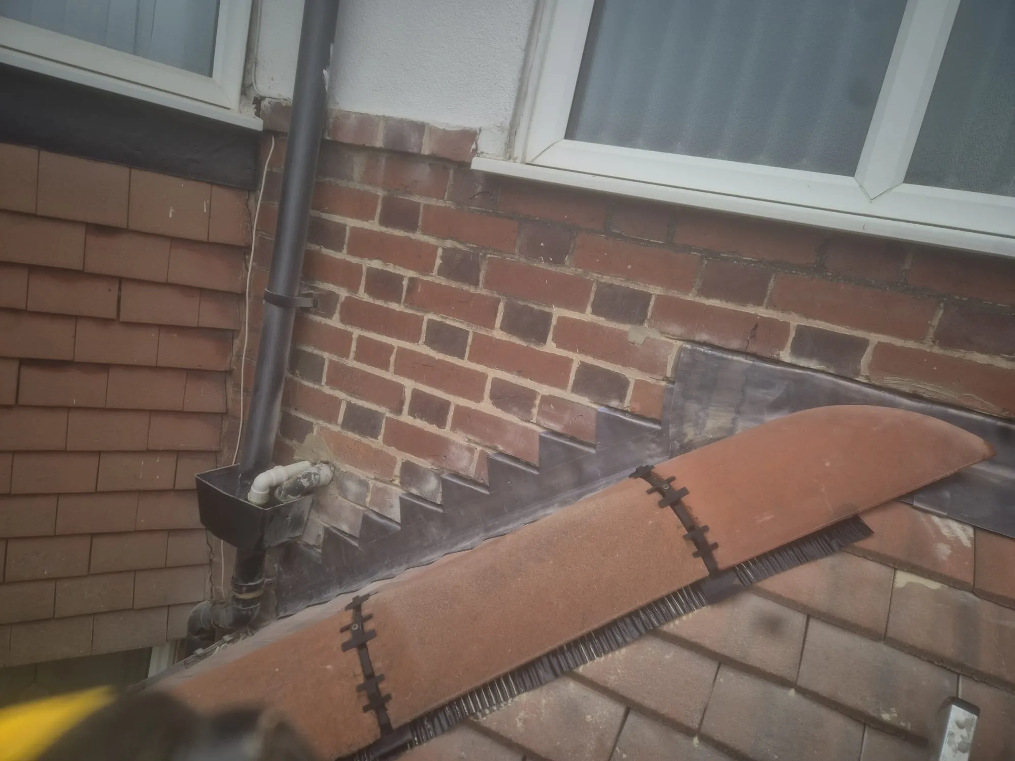 Expertly installed stepped lead flashing and dry ridge system on a tiled roof in Hampshire.