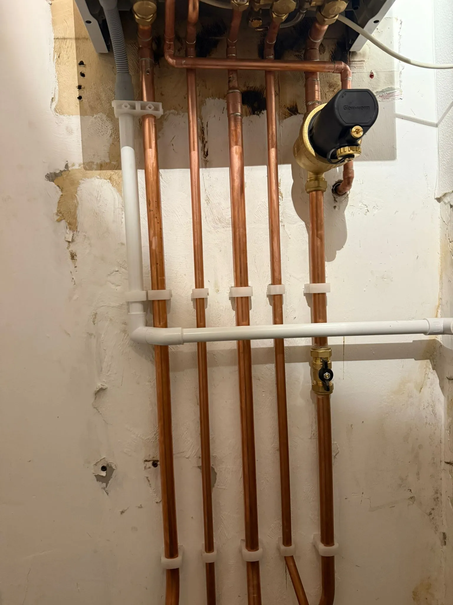 Close-up of boiler pipework and a magnetic filter installed by Redorr Heating & Cooling Services Ltd.