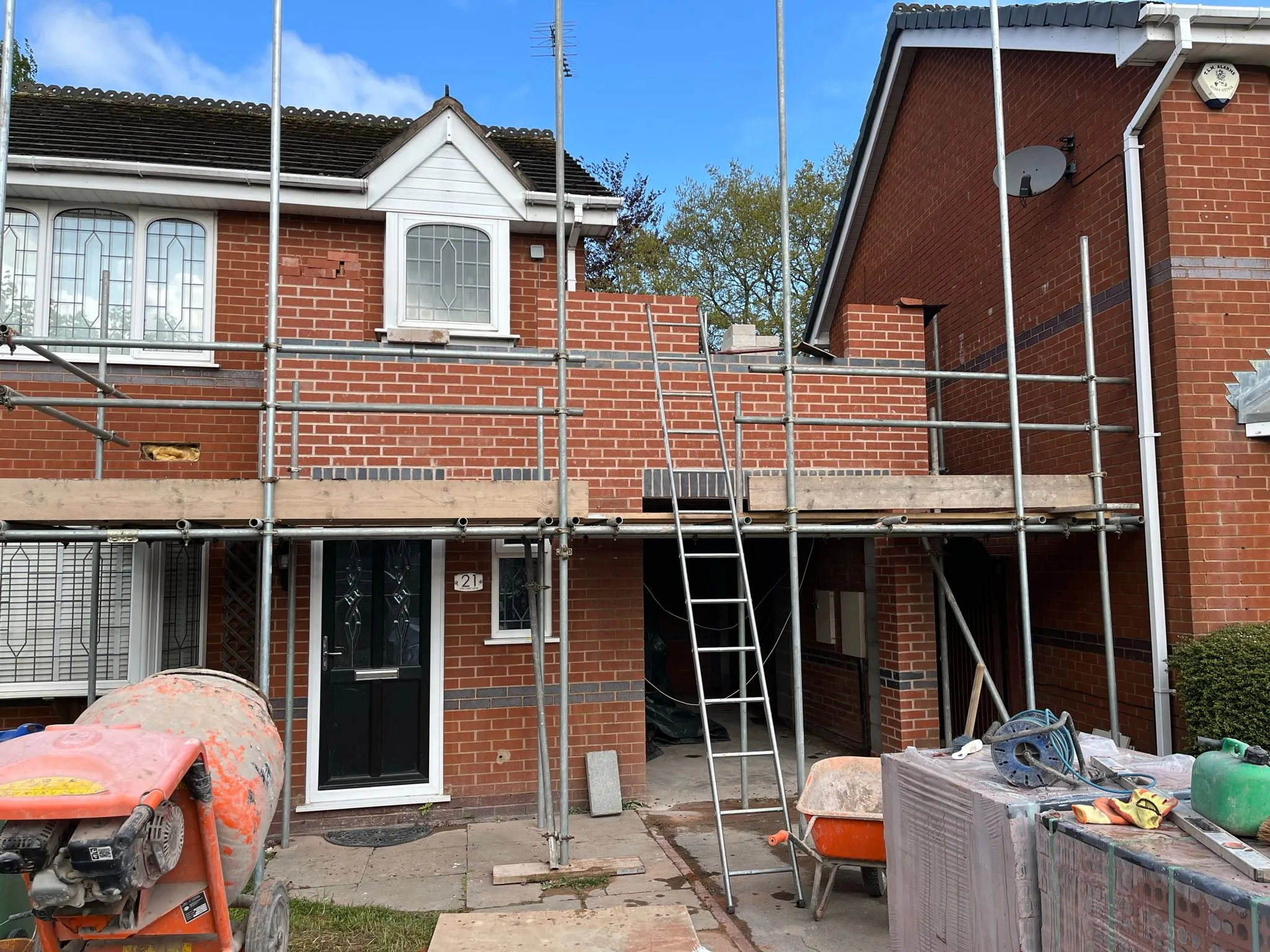 Two-storey home extension under construction with scaffolding and building materials on a house in Stourbridge.
