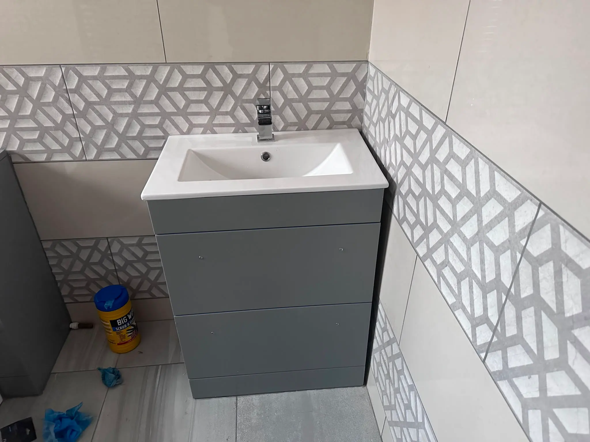 Modern bathroom sink and grey vanity unit installed by JMA Plumbing & Heating