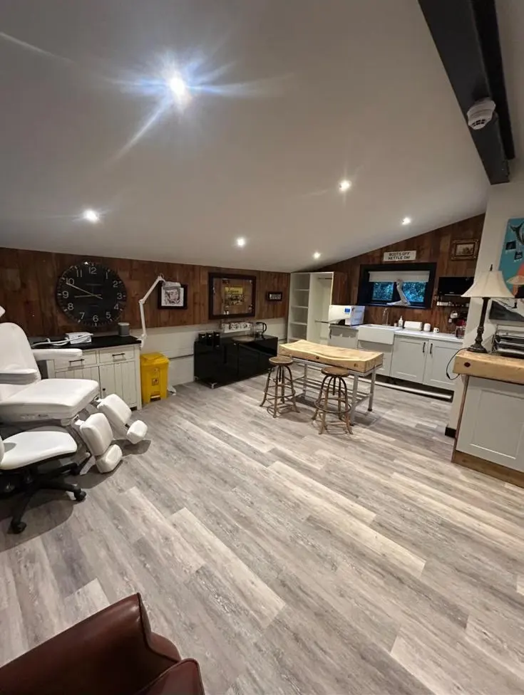 A modern, fully wired studio or treatment room with LED downlights and a treatment chair.