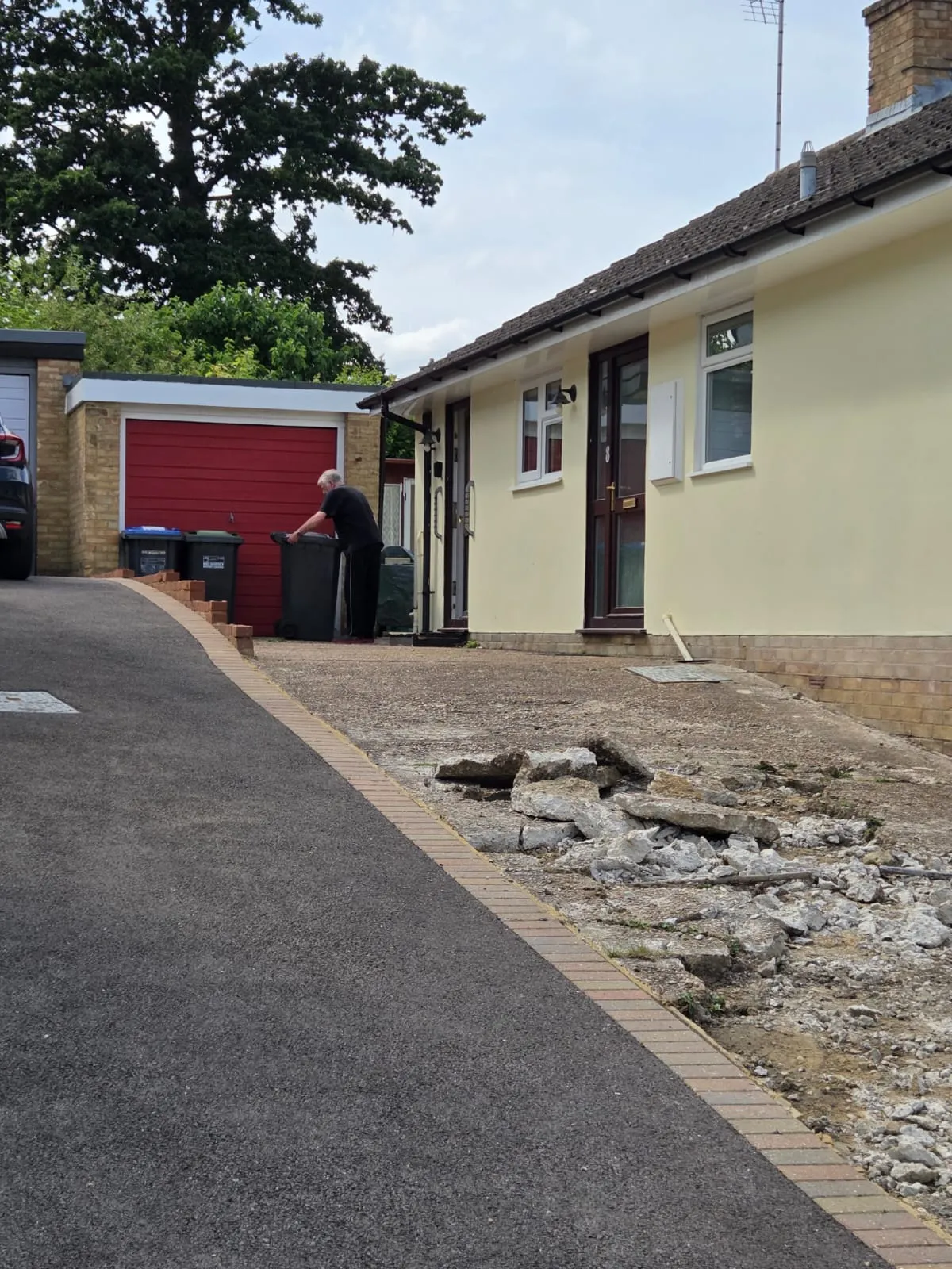 Work in progress of a professional tarmac driveway installation at a residential property