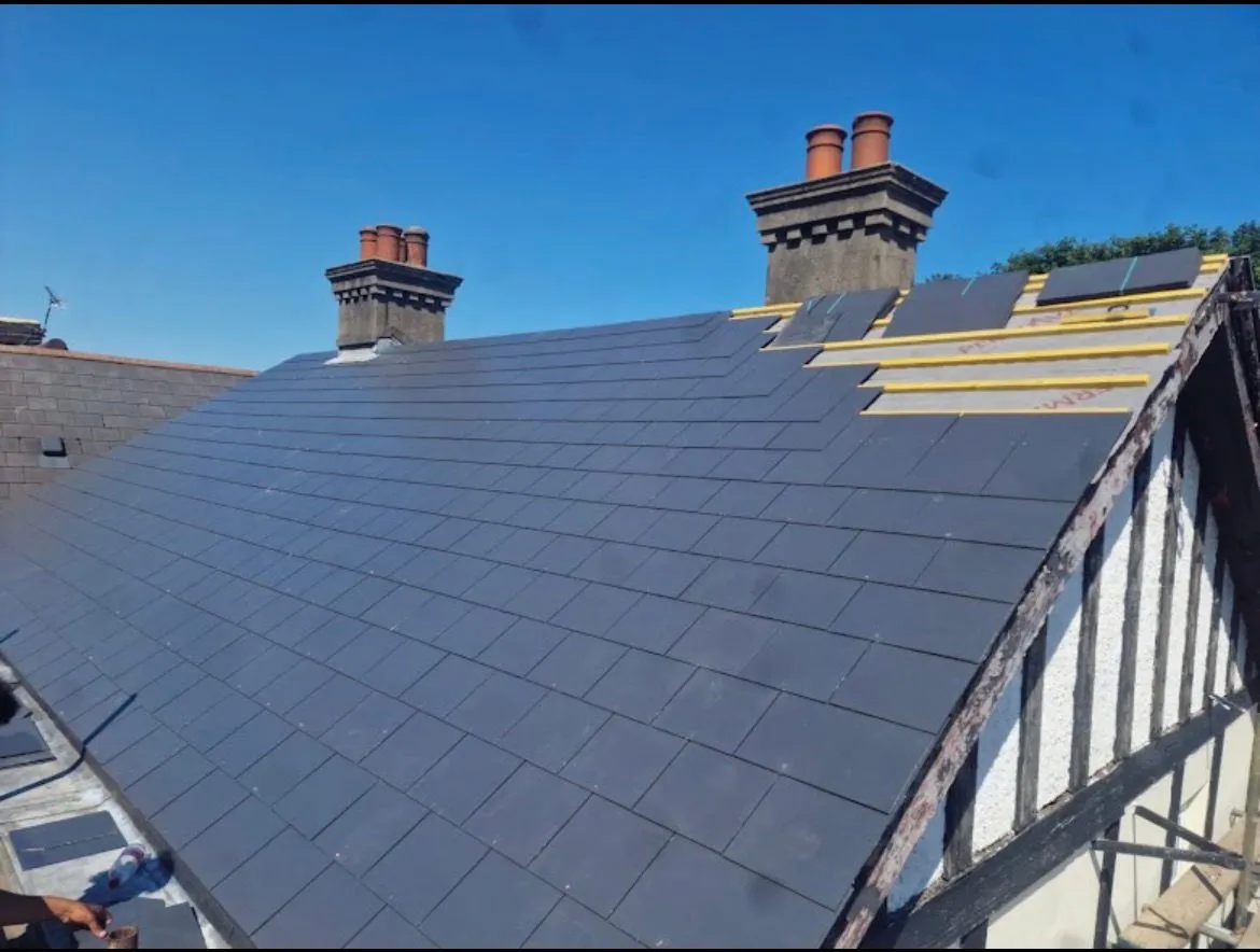 Slate roof replacement in progress with new battens, breathable membrane, and slates laid on a pitched residential roof