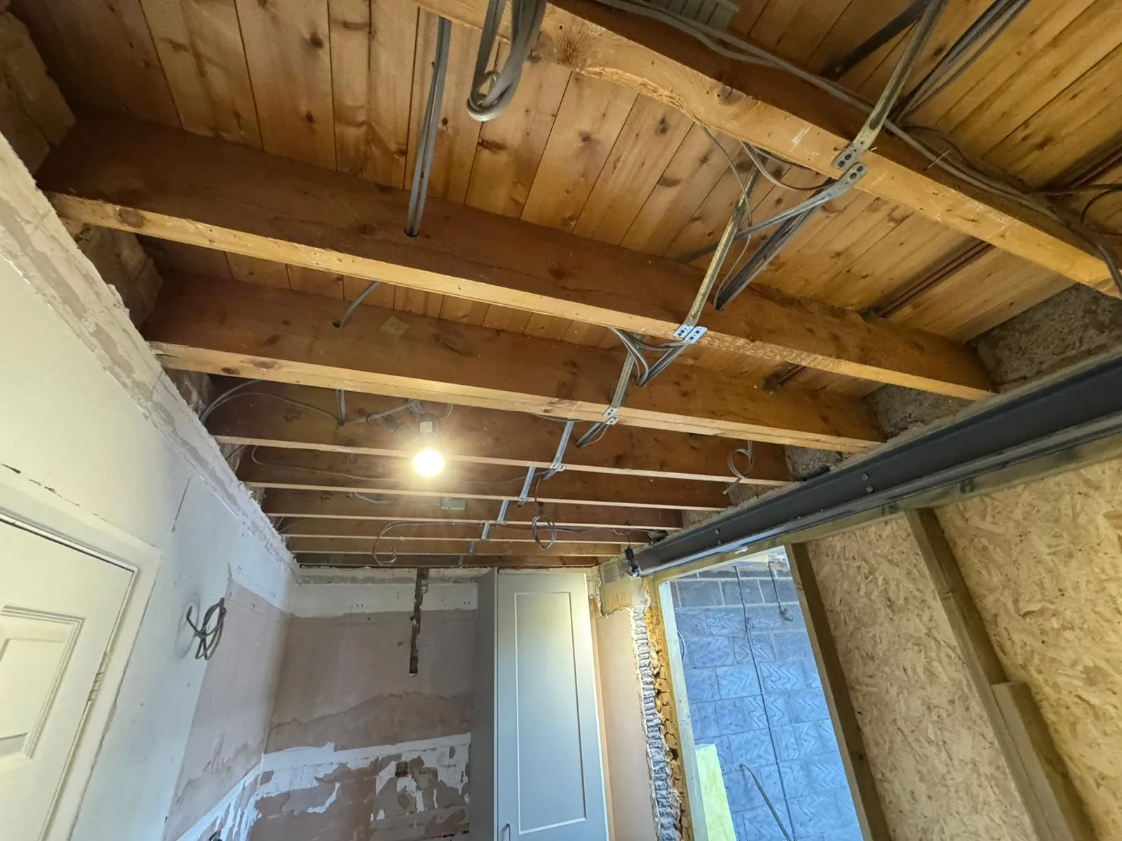 First-fix electrical wiring and ceiling joist installation during a house rewire in Felixstowe by FLEX PROPERTY SERVICES.