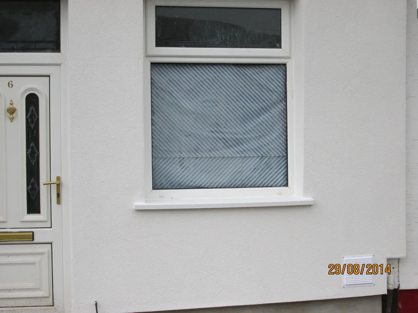Close-up of newly applied white silicone rendering on a residential property exterior