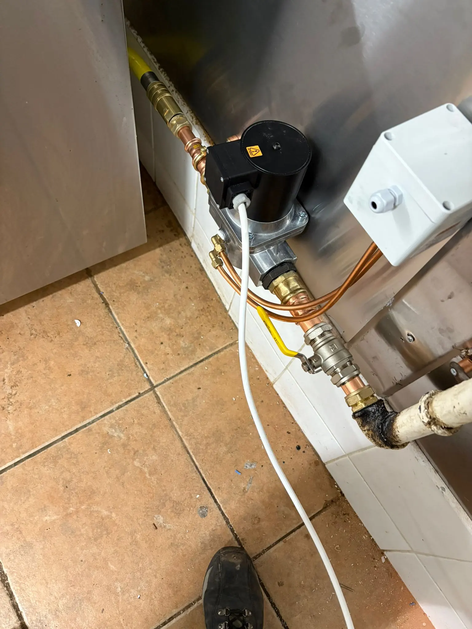 Gas solenoid valve and interlock system installation in a commercial kitchen