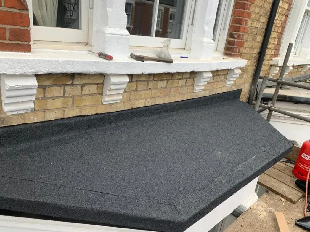 Professional flat roof installation on a bay window in Plymouth by Sky Top Roofing LTD.