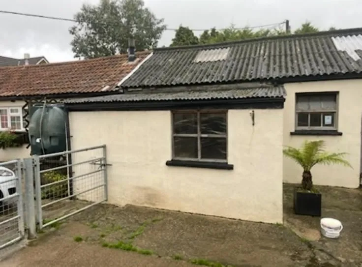 An outbuilding with a corrugated asbestos cement roof in Hampshire.