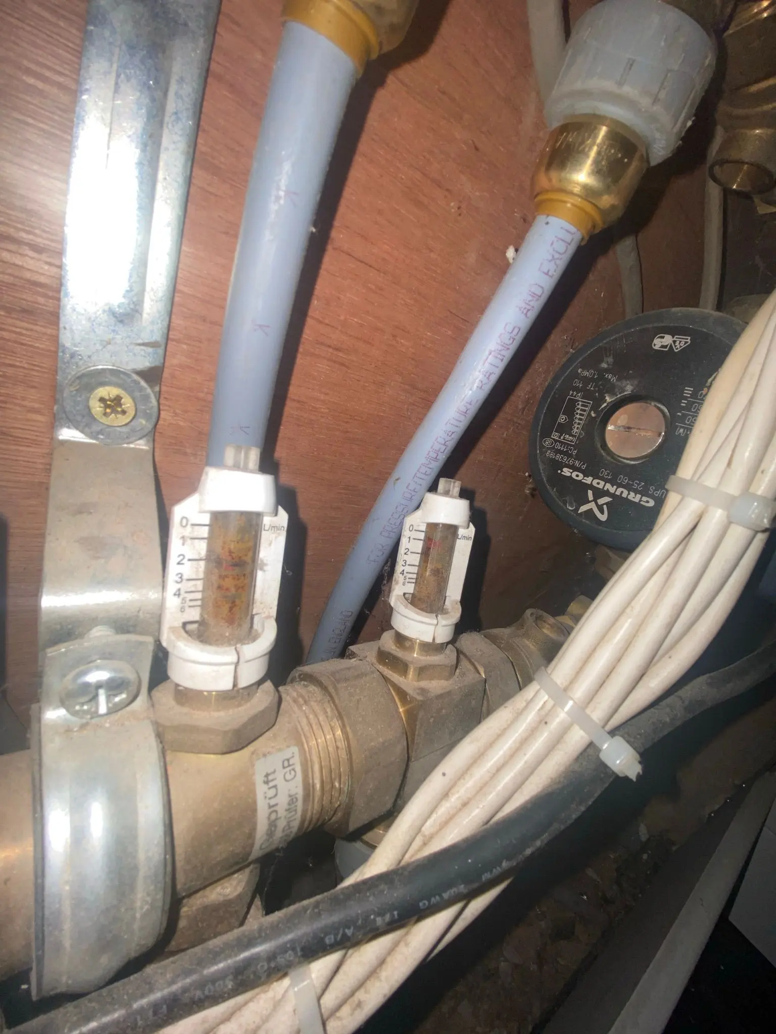 Underfloor heating manifold with flow meters and Grundfos pump in a residential property