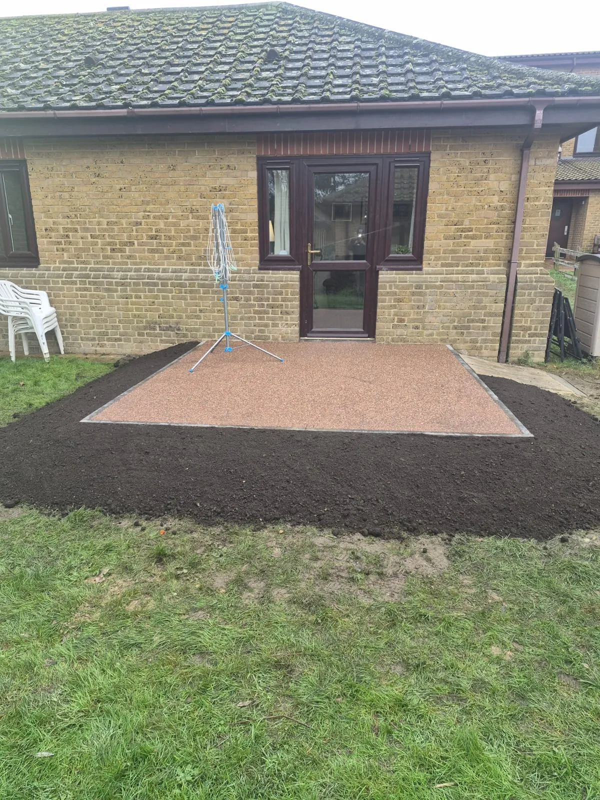 Professional resin surfacing patio installation in a residential garden by Kent Paving & Resin LTD