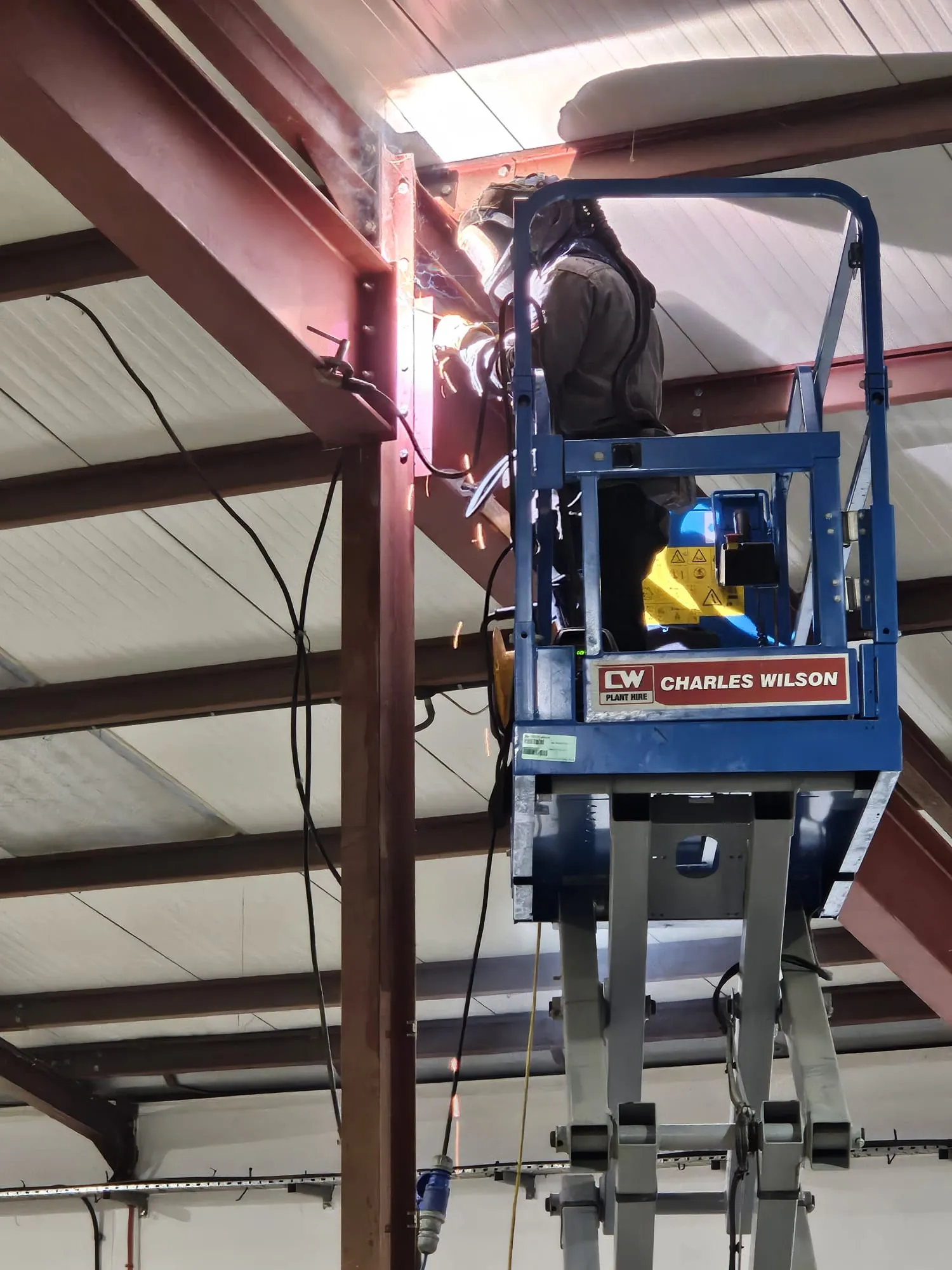 Coded welder performing mobile site welding on structural steel beams for a commercial building project in Southampton.