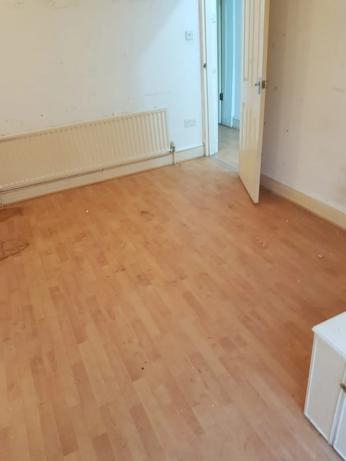 Cleared domestic room with laminate flooring after a house clearance service