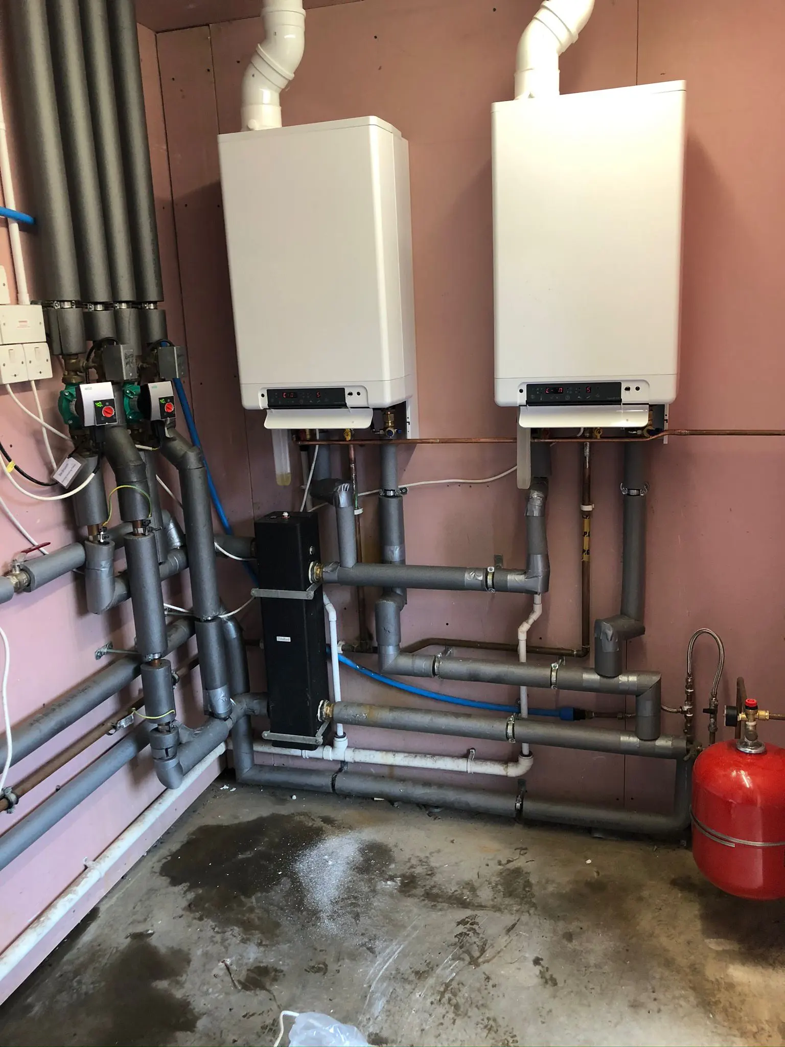 Professional dual commercial boiler installation with insulated pipework and circulation pumps by Fact Services in Wolverhampton.