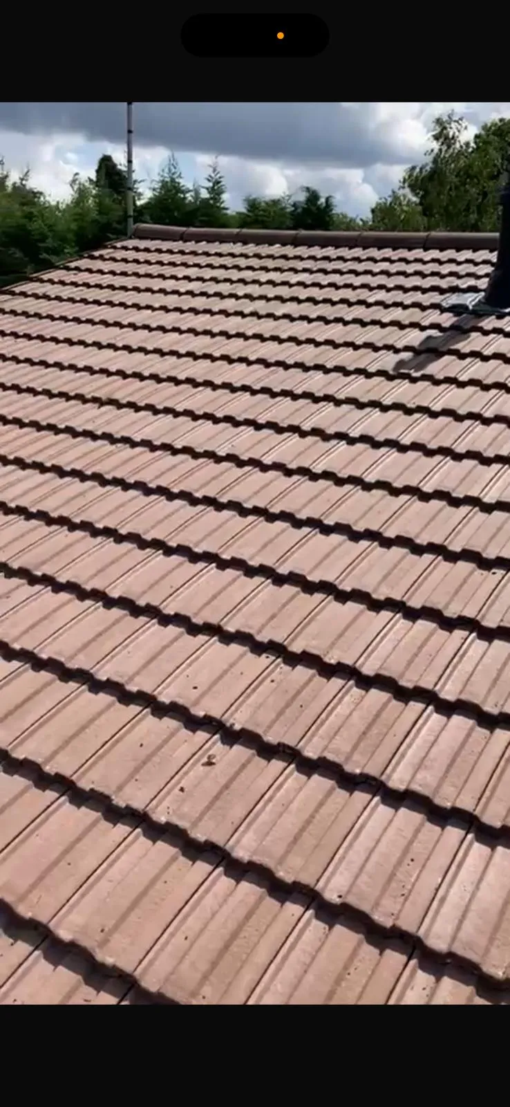Newly installed brown interlocking roof tiles on a pitched roof in West Malling, Kent.