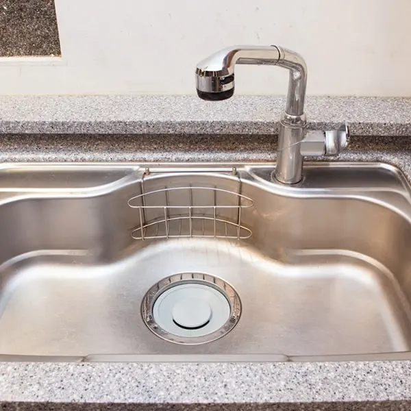 A stainless steel kitchen sink representing expert blocked sink repairs by Drain Medics