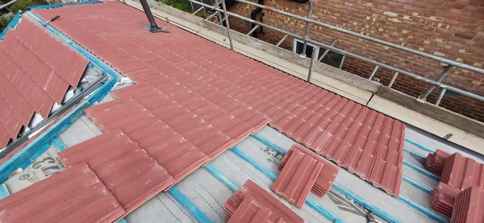 New red concrete roof tile installation on treated battens with breathable membrane