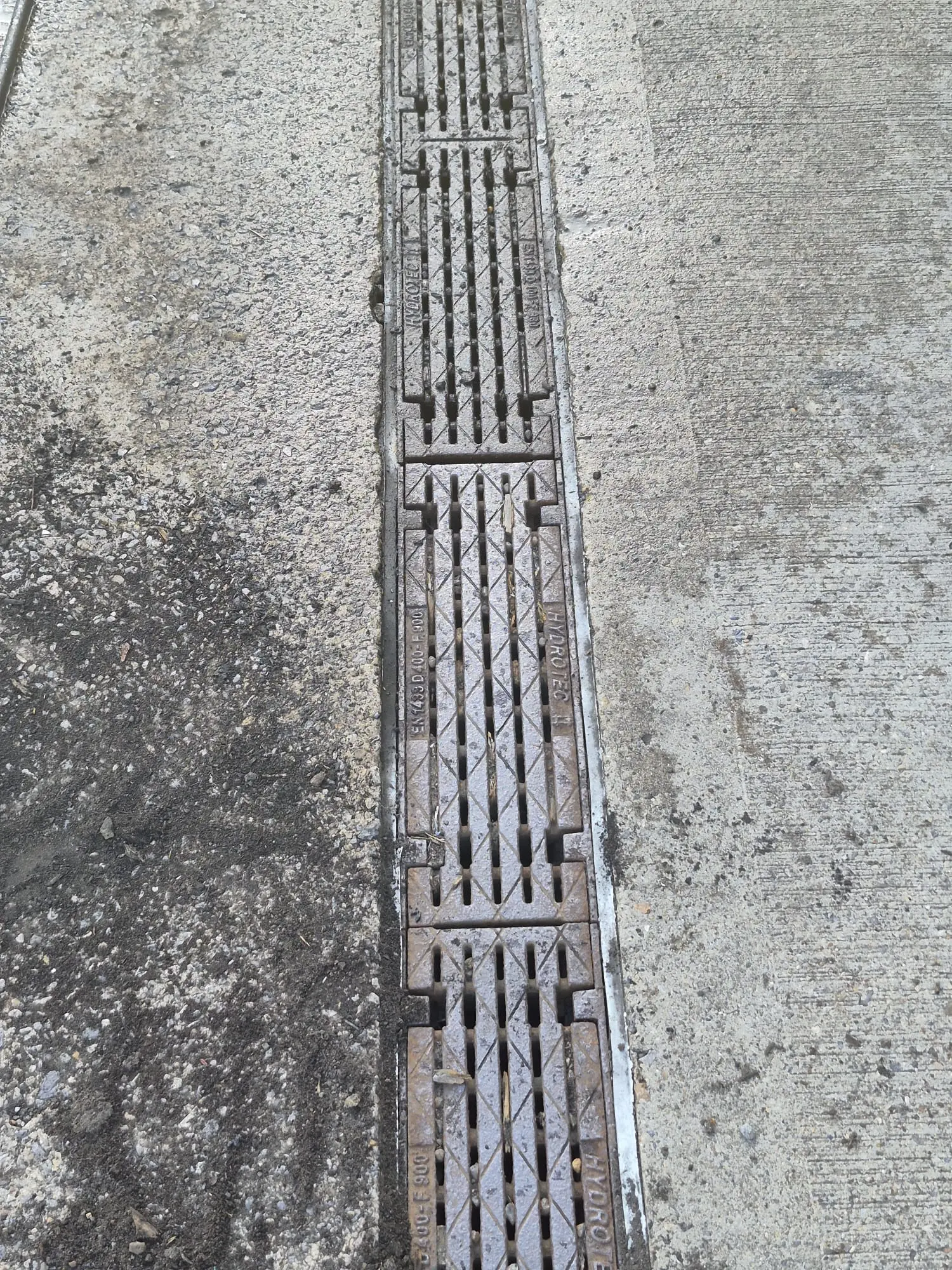 Heavy-duty commercial trench drain grate installed in a concrete surface