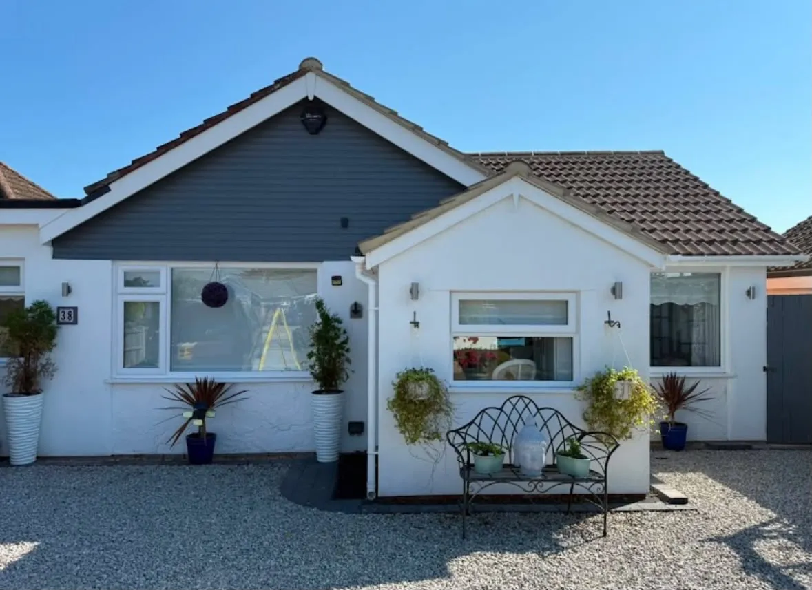 Exterior of a residential property with modern outdoor lighting and security alarm installed by Sussex Brown Sparks