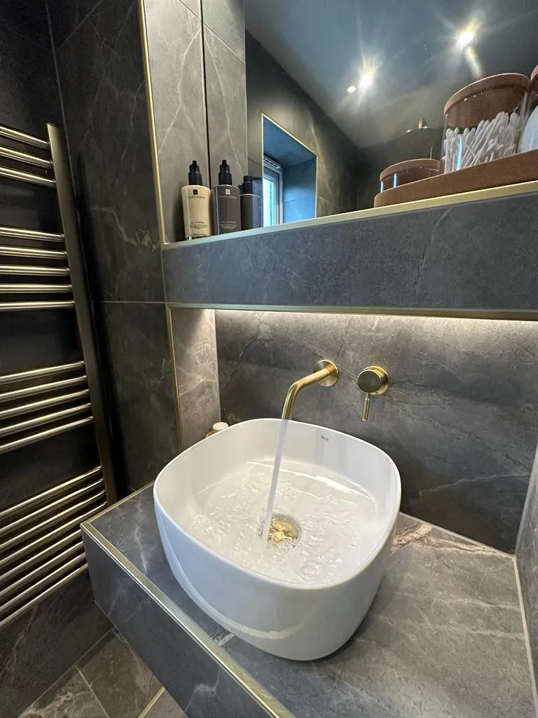 High-end bespoke bathroom design by Sands & Vossen featuring a luxury vessel basin and brass fixtures in a Plymouth home.