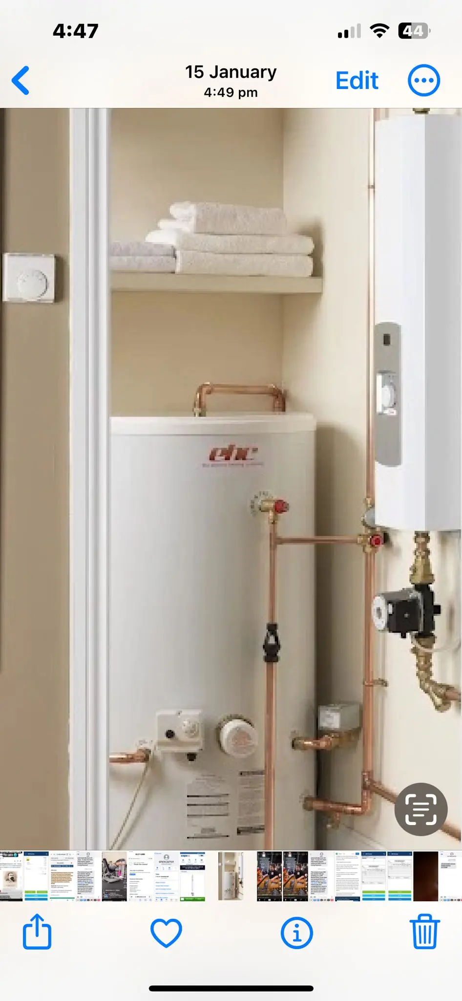 A hot water cylinder and electric boiler installation in a residential cupboard
