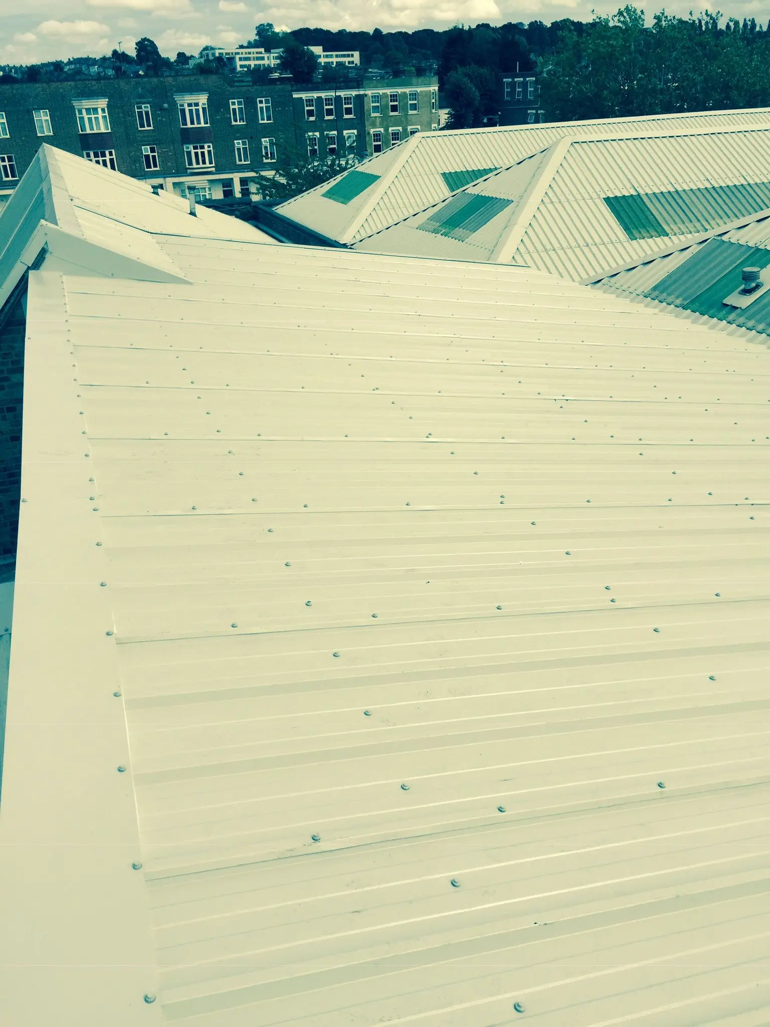 Newly installed corrugated metal roofing on a commercial industrial building by ER3 Group LTD.