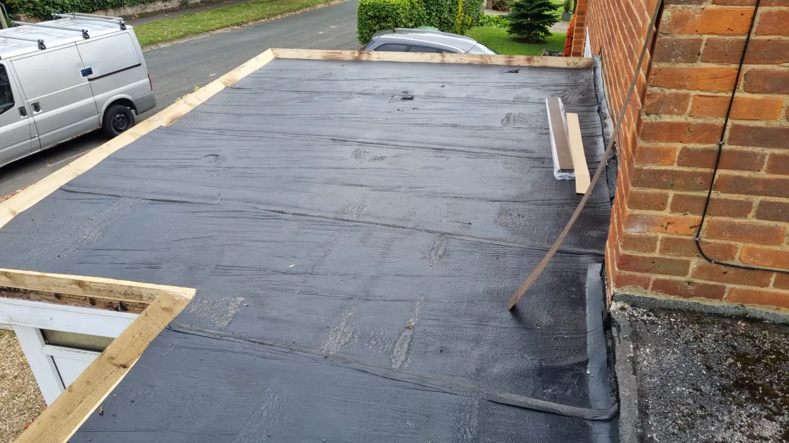 Flat roof installation in progress on a residential extension