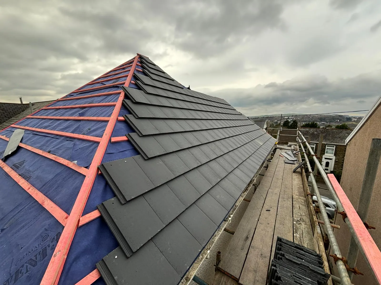 New pitched roof installation in Gloucestershire showing grey tiles and roof underlay