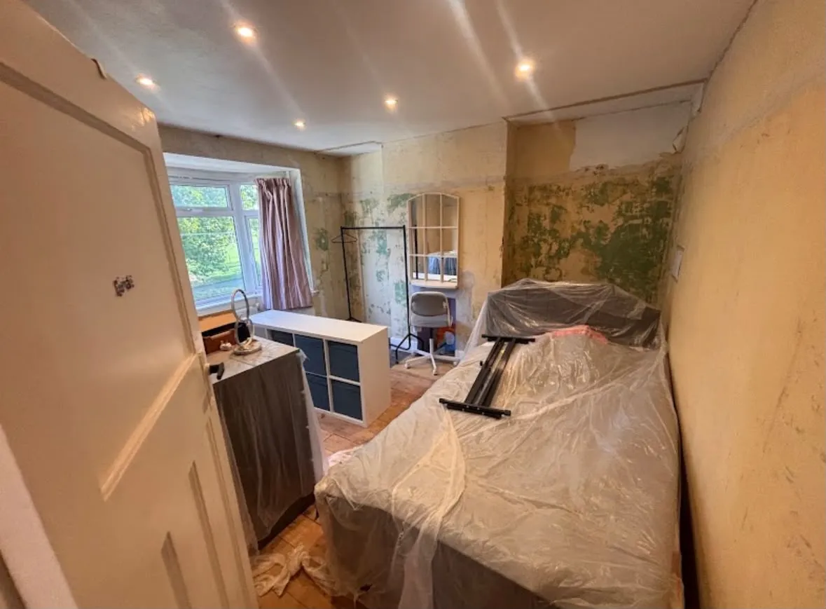 Domestic bedroom renovation featuring newly fitted recessed LED downlights and preparation for rewiring