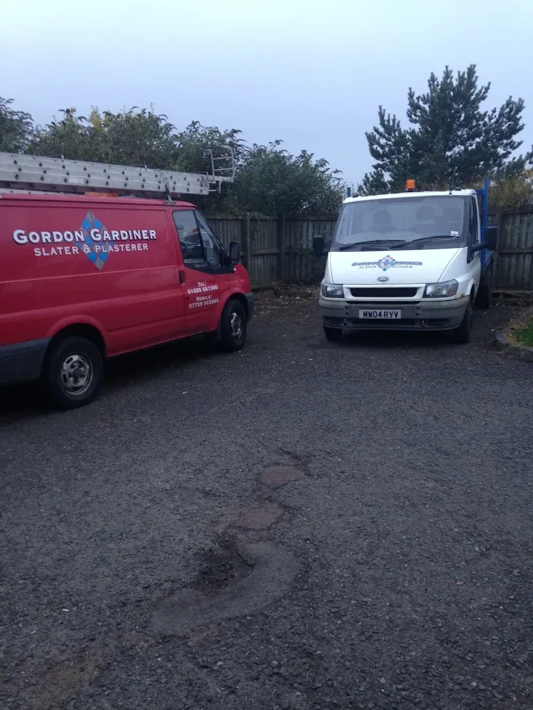 Two branded work vans for Gordon Gardiner Slater & Plasterer parked outside in Lanark.