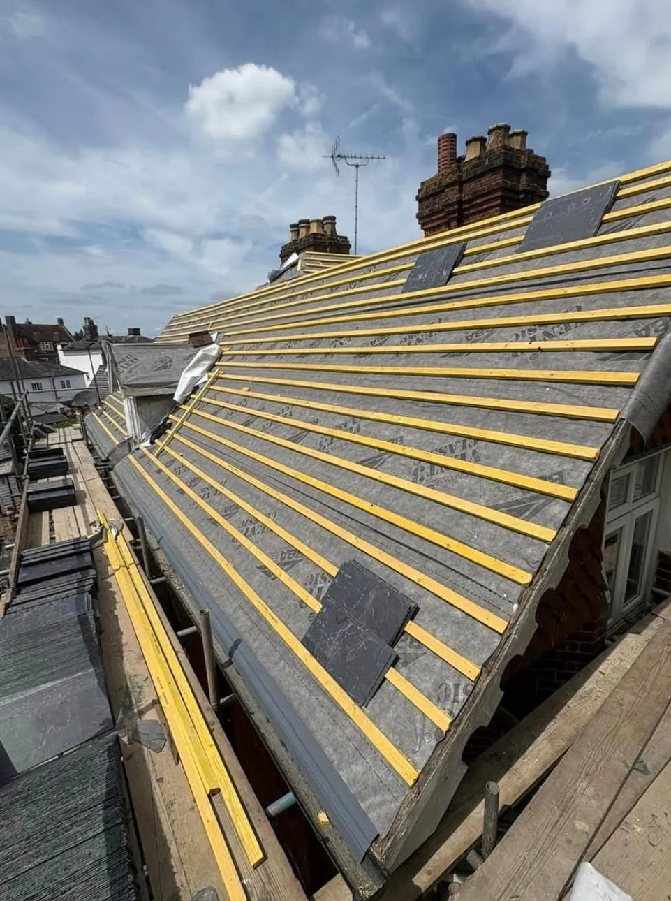 Battening and breathable underlay installed on a pitched roof ready for slate replacement