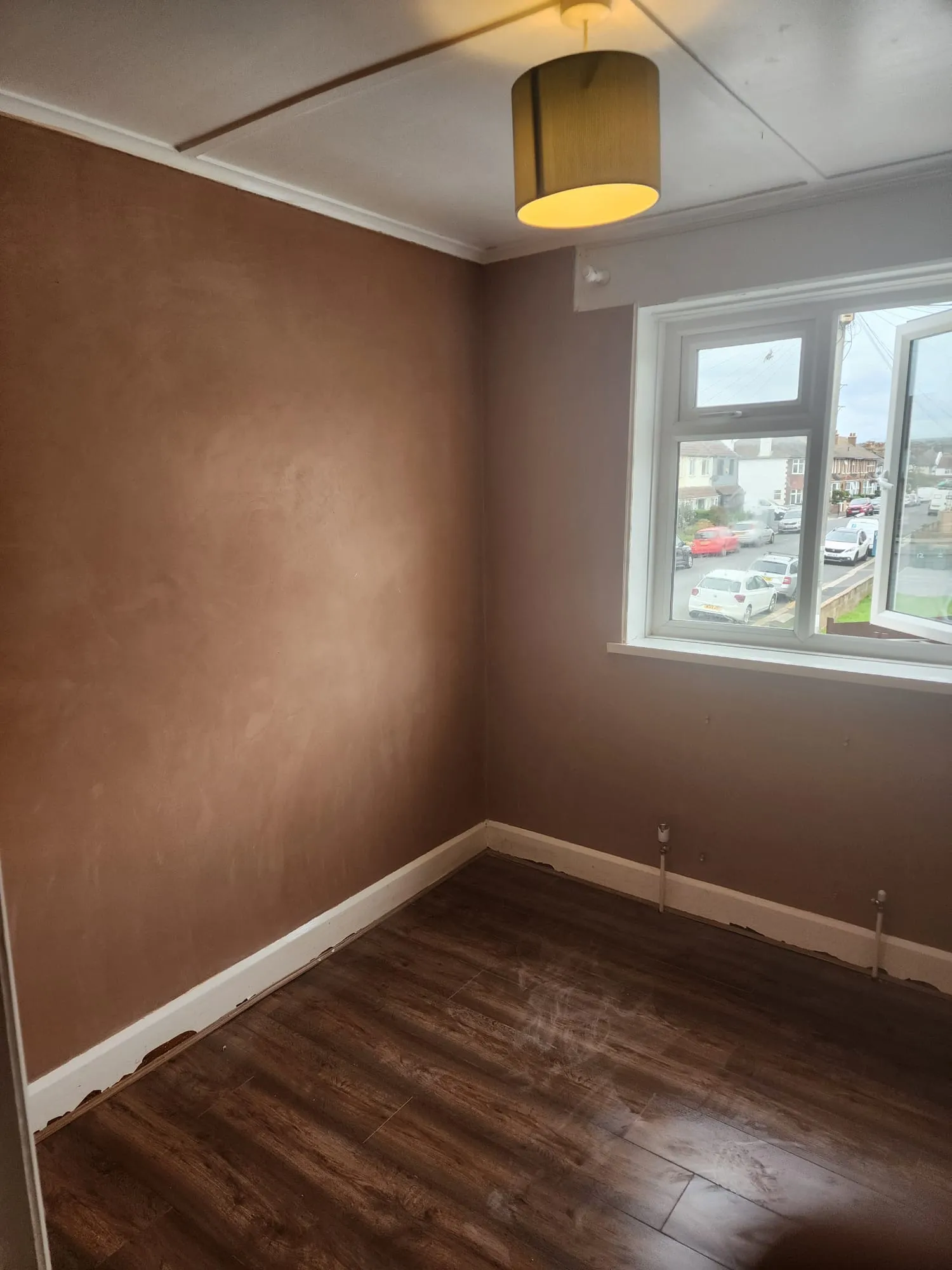 Professional internal plastering and skimming on bedroom walls in a residential property.