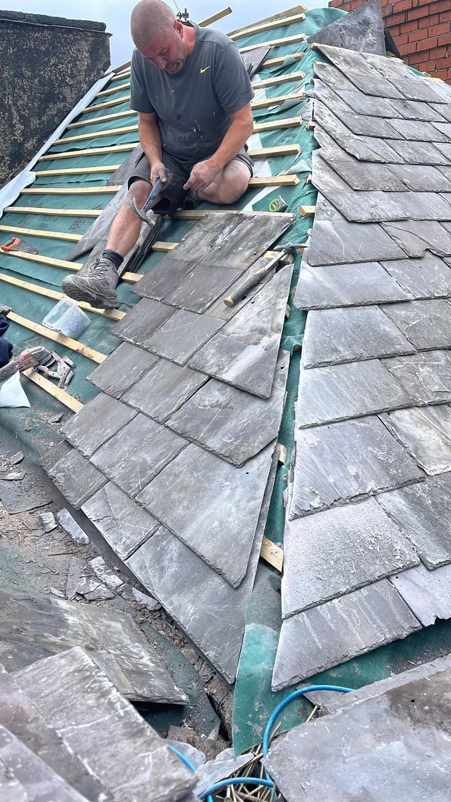 Expert roofer from Premium Roofing Contractors installing a new slate roof in Cheshire