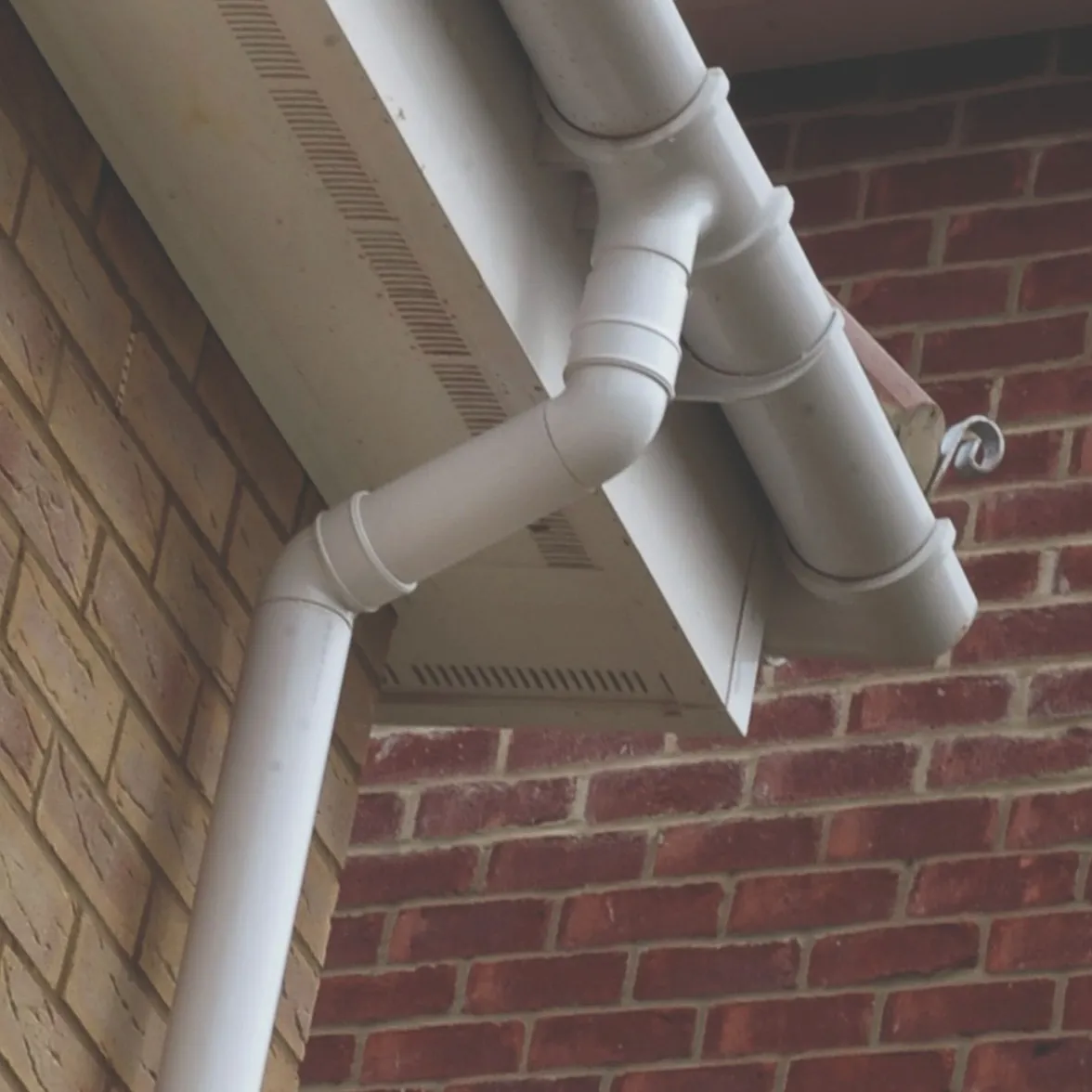 White UPVC fascias, soffits, and guttering installed on a brick house.