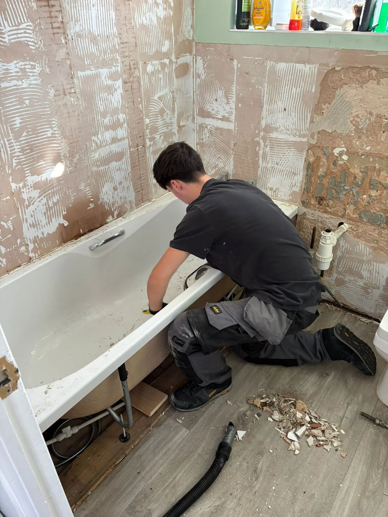 Professional bathroom refurbishment in Wolverhampton showing a bathtub installation in progress by Fact Services.